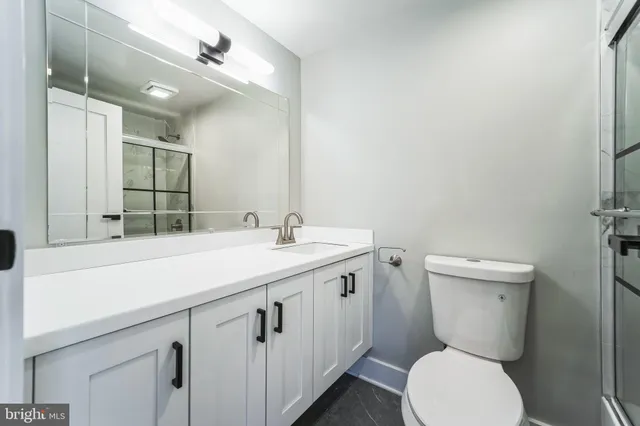 a bathroom with a toilet sink and mirror