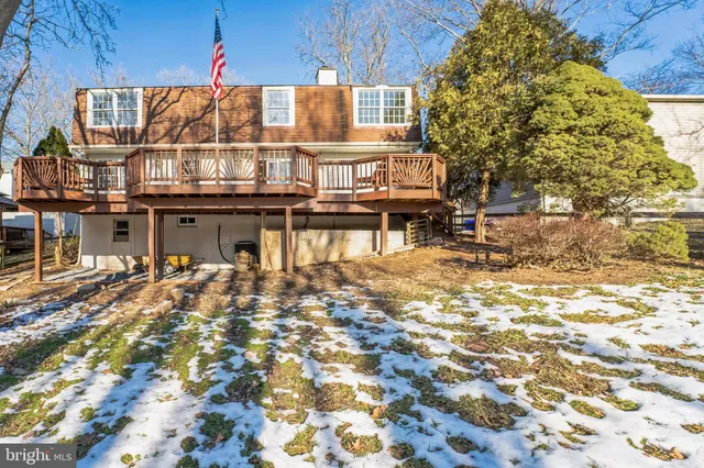 front view of a house with a large tree