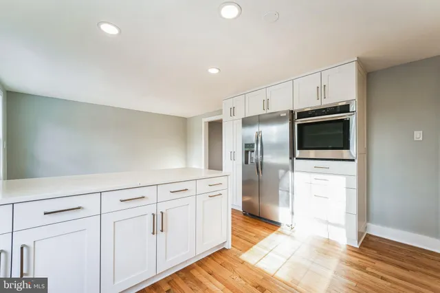 a kitchen with stainless steel appliances a refrigerator sink and microwave