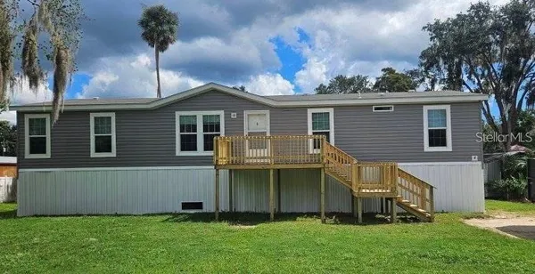 a front view of a house with a garden and yard