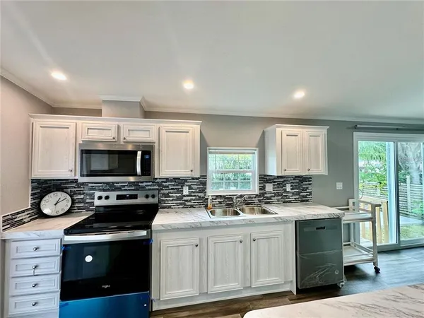 a kitchen with a sink stove and cabinets