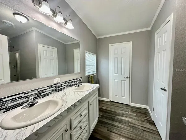 a bathroom with a double vanity sink and a mirror