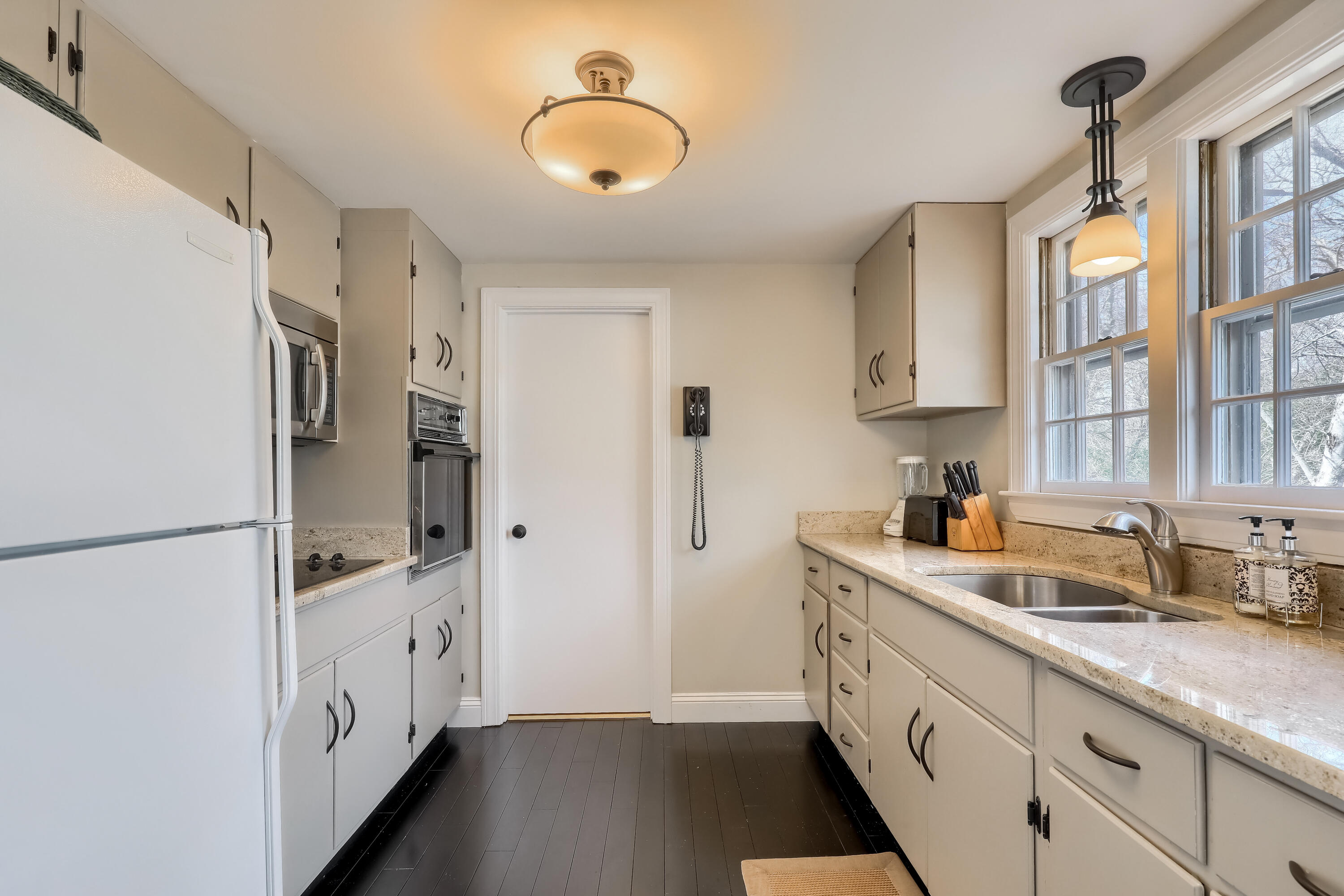 177 Old Stage Road Centerville, MA 02632 - Photo 13 of 29 a kitchen with a refrigerator a sink and dishwasher with wooden floor