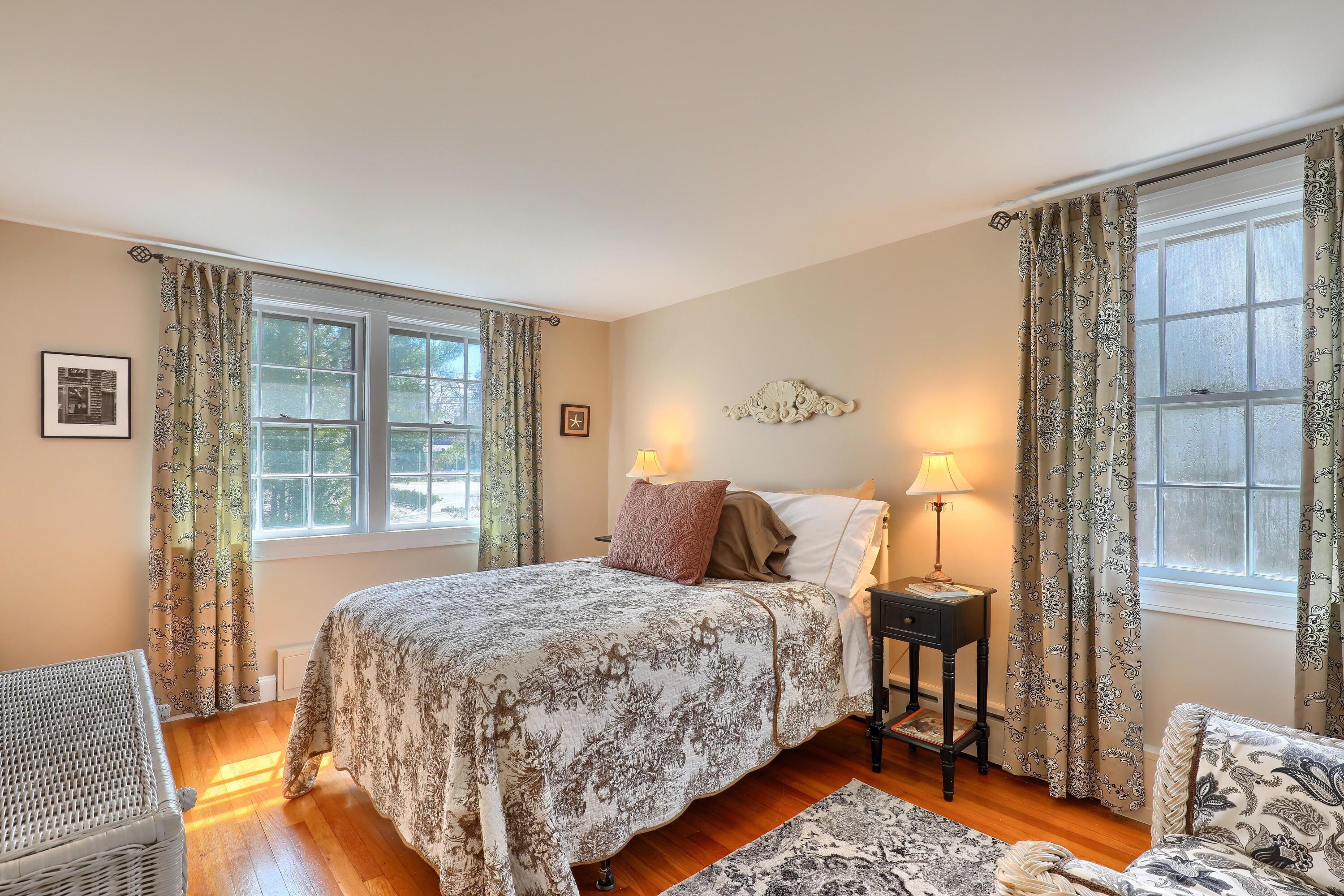 177 Old Stage Road Centerville, MA 02632 - Photo 21 of 29 a bedroom with a bed and wooden floor