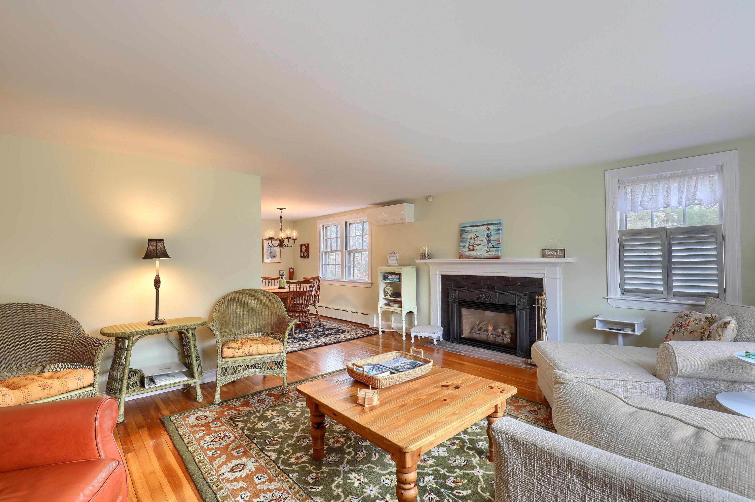 177 Old Stage Road Centerville, MA 02632 - Photo 7 of 29 a living room with furniture and a fireplace