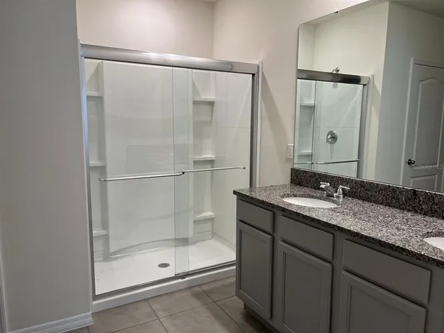 a bathroom with a granite countertop sink mirror and double