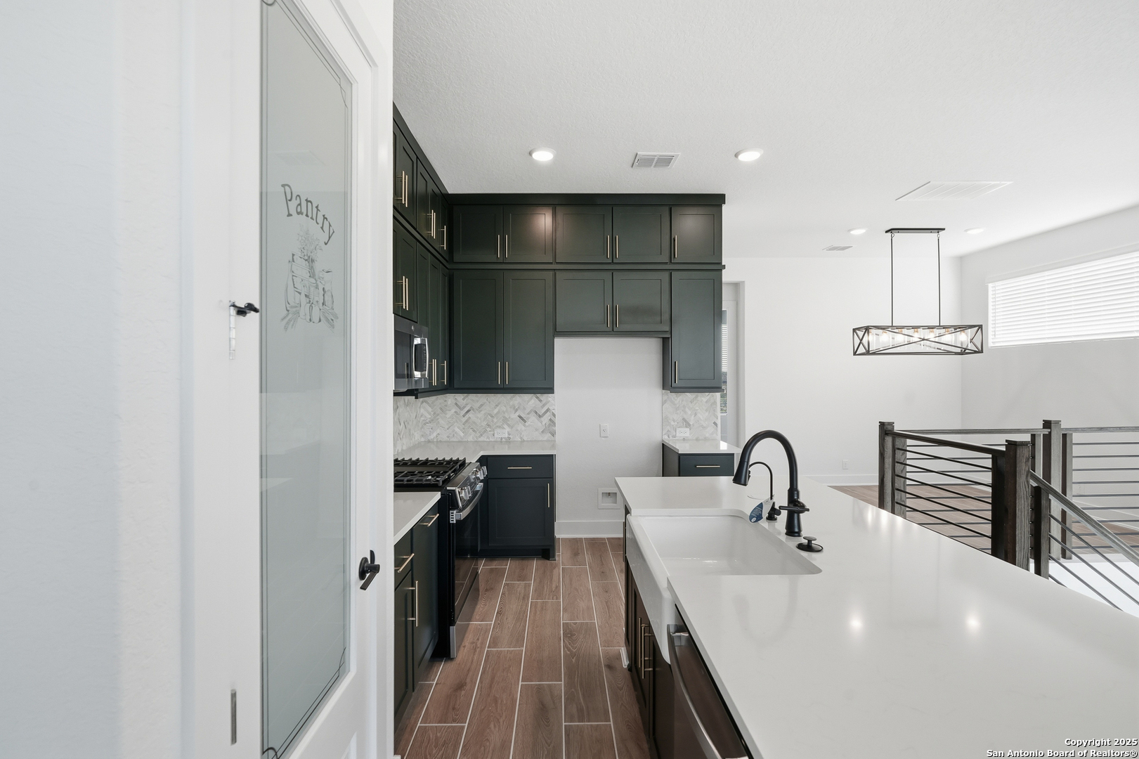 20675 Huebner Road, Unit 526 San Antonio, TX 78258 - Photo 13 of 45 a kitchen with kitchen island a sink appliances and cabinets