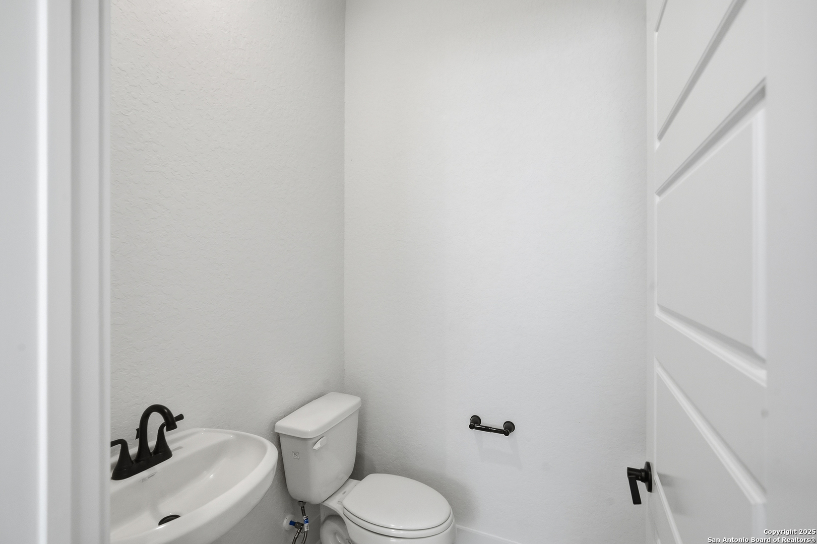 20675 Huebner Road, Unit 526 San Antonio, TX 78258 - Photo 21 of 45 a white toilet sitting next to a bathroom sink