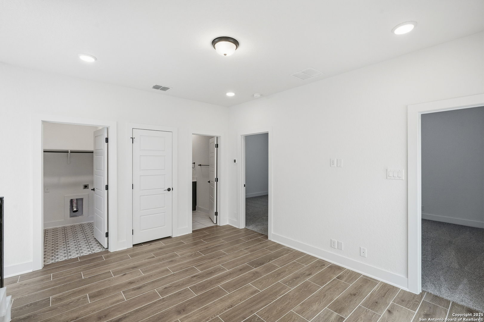 20675 Huebner Road, Unit 526 San Antonio, TX 78258 - Photo 31 of 45 a view of an empty room with wooden floor and a bathroom