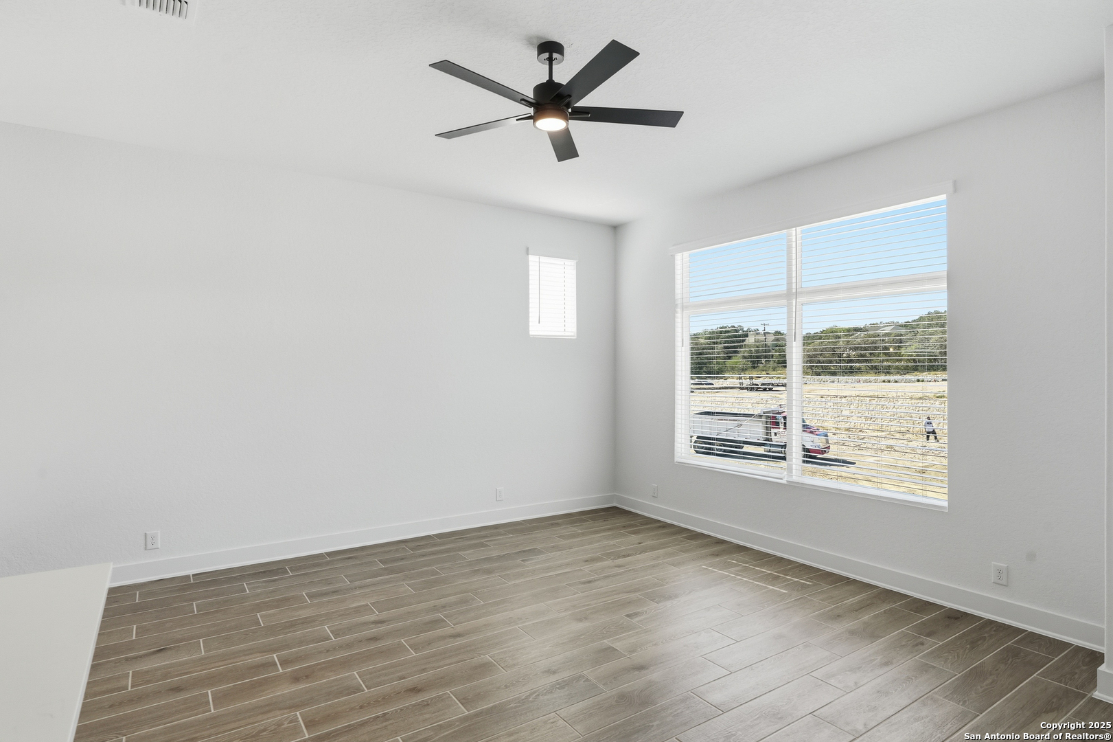 20675 Huebner Road, Unit 526 San Antonio, TX 78258 - Photo 8 of 45 wooden floor in an empty room with a window