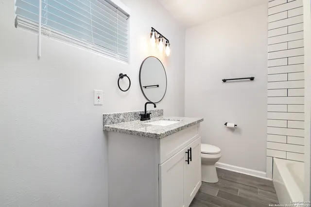 a bathroom with a toilet and a sink
