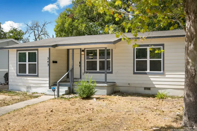 a front view of a house with a lounge chairs in patio