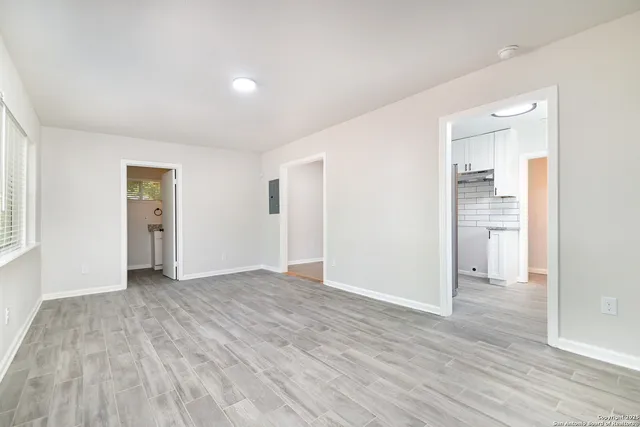 wooden floor in an empty room with a window