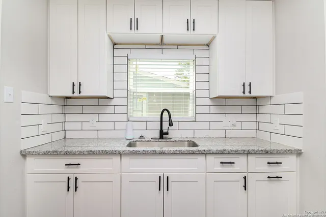 a kitchen with a sink and cabinets