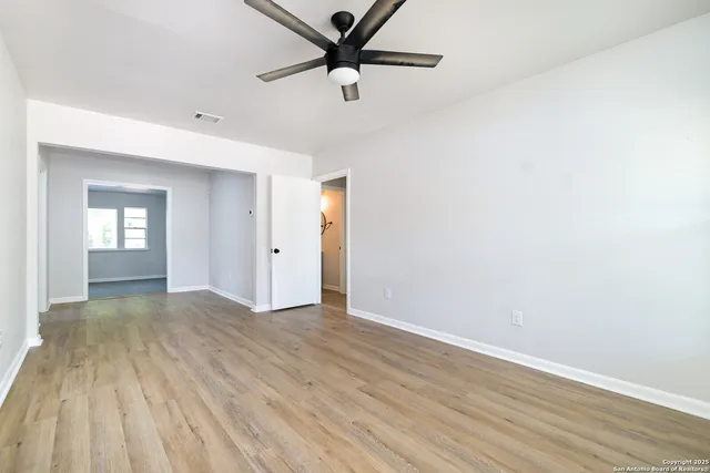 a view of a livingroom with a ceiling fan and wooden floor