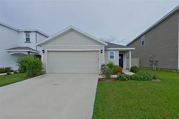 a view of a house with a yard and garage