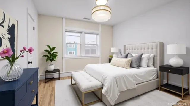 a bedroom with bed and wooden floor