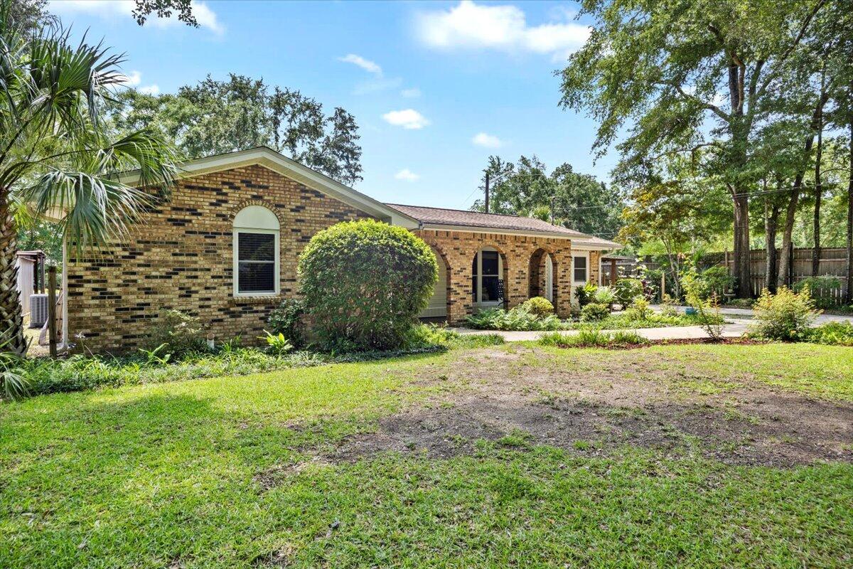 a front view of a house with yard and green space
