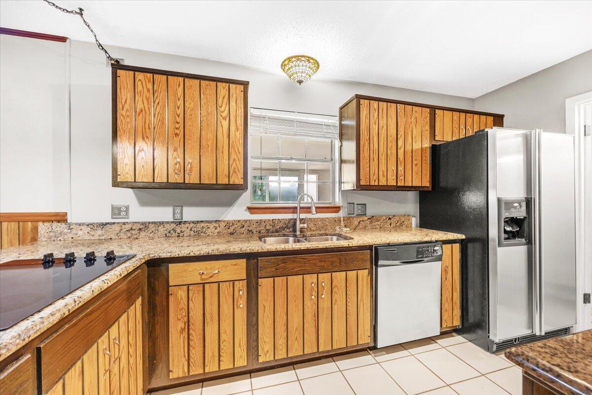 295 Garden Street Crestview, FL 32536 - Photo 12 of 33 a kitchen with stainless steel appliances granite countertop a refrigerator and a sink