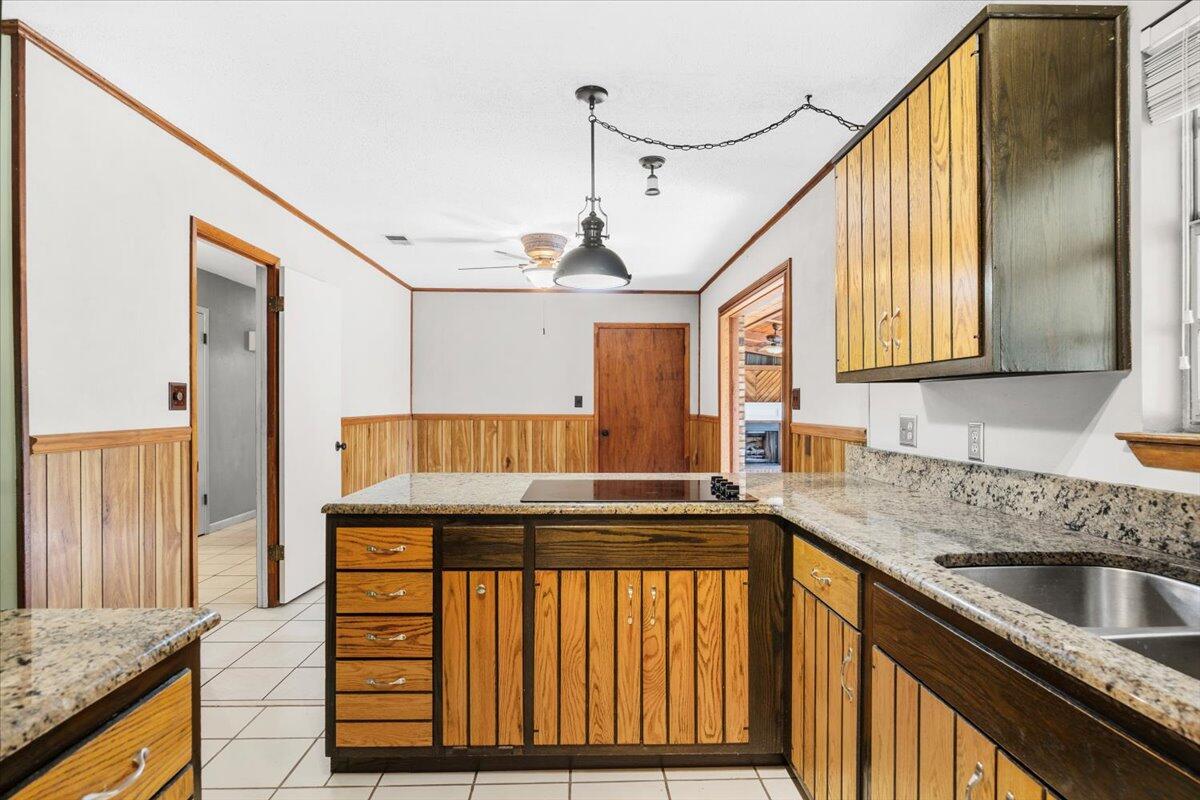 295 Garden Street Crestview, FL 32536 - Photo 13 of 33 a kitchen with stainless steel appliances granite countertop a sink and a refrigerator