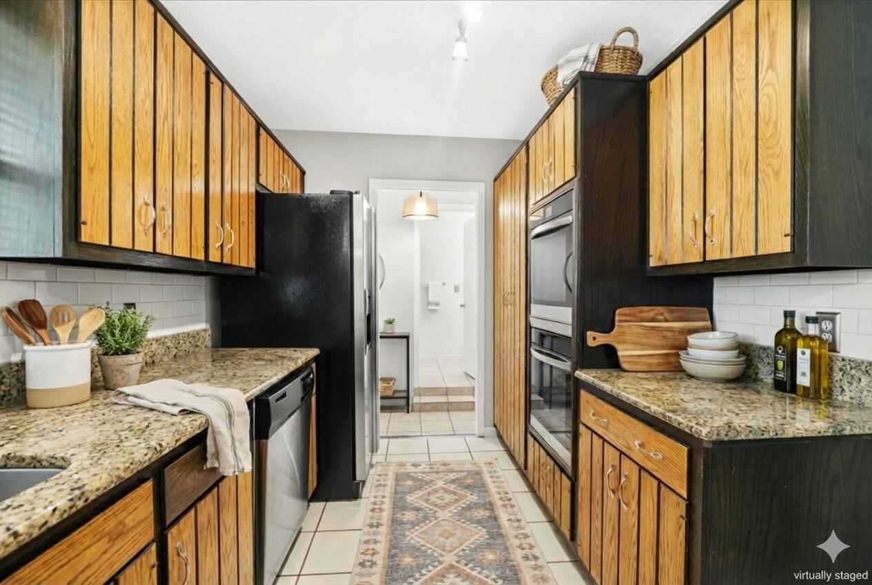 295 Garden Street Crestview, FL 32536 - Photo 14 of 33 a kitchen with stainless steel appliances granite countertop a sink stove and refrigerator