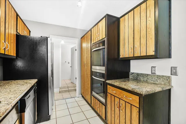 a kitchen with a stove a sink and a refrigerator