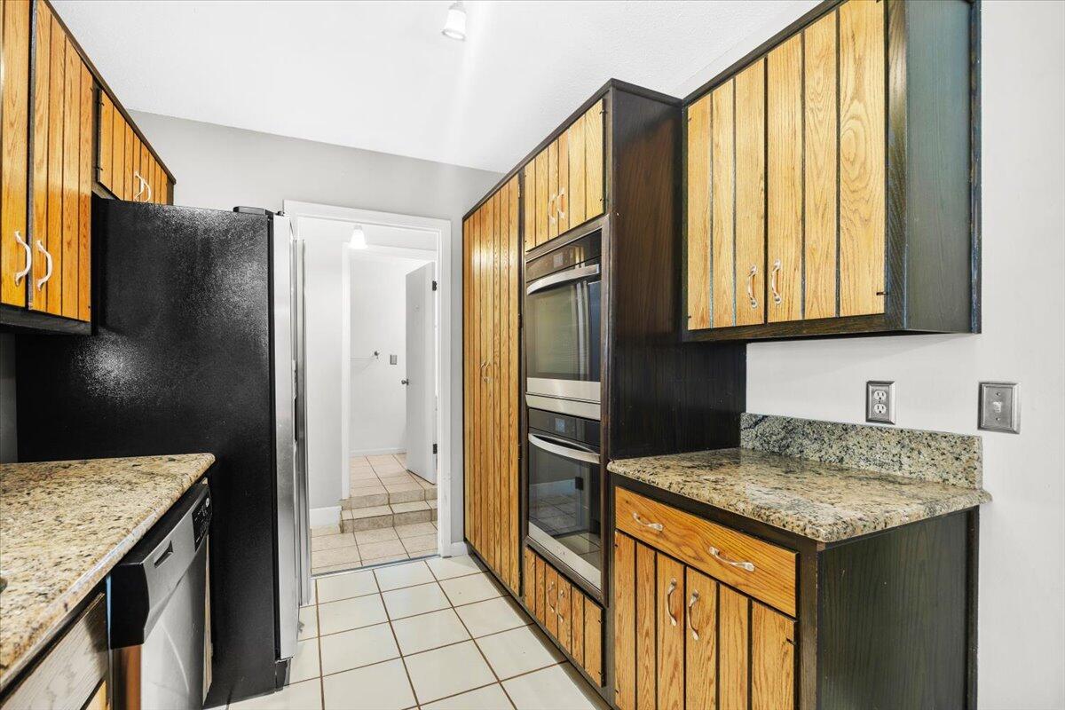 295 Garden Street Crestview, FL 32536 - Photo 15 of 33 a kitchen with stainless steel appliances granite countertop a refrigerator and a sink
