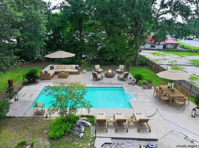 a living room with furniture a flat screen tv and a window