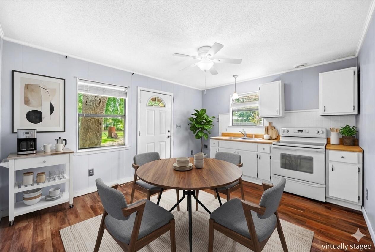 295 Garden Street Crestview, FL 32536 - Photo 24 of 33 a kitchen with stainless steel appliances kitchen island a table and chairs in it