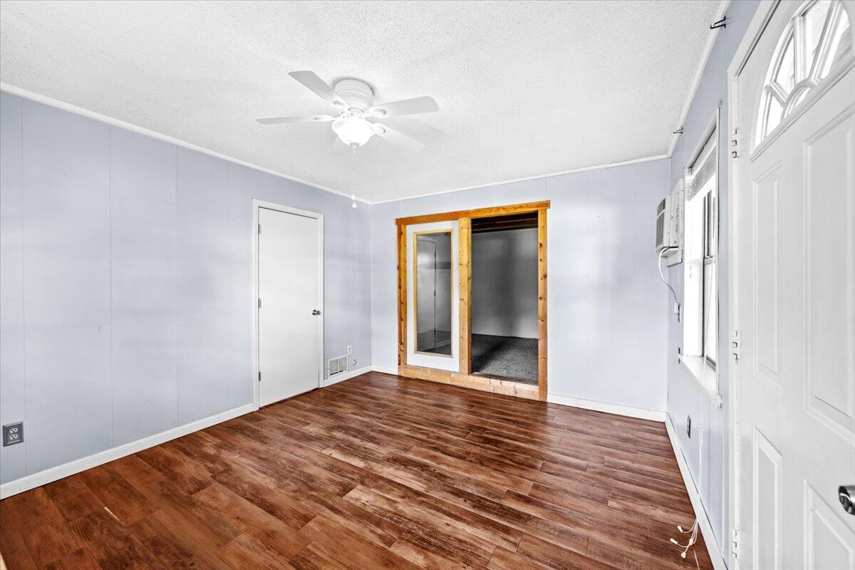 295 Garden Street Crestview, FL 32536 - Photo 27 of 33 a view of an empty room with wooden floor and a window