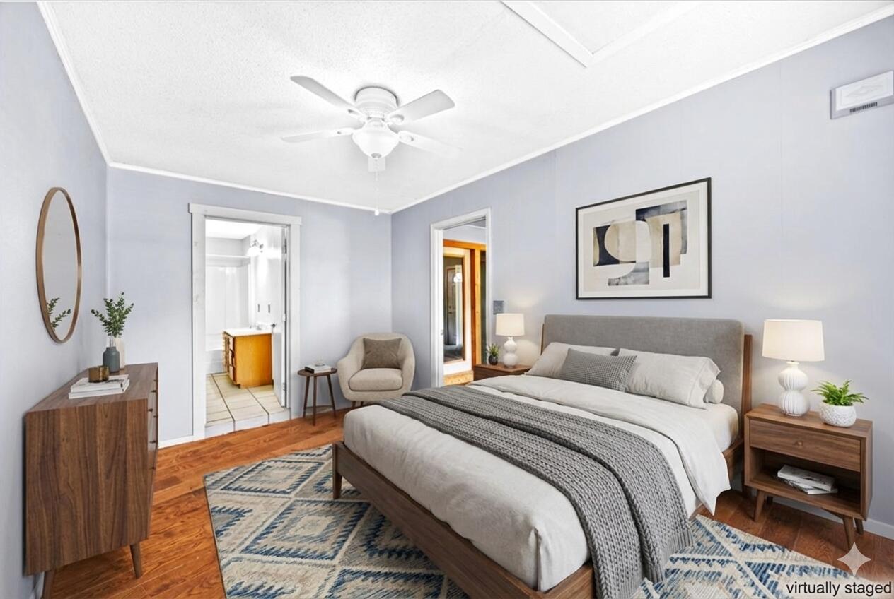 295 Garden Street Crestview, FL 32536 - Photo 28 of 33 a bedroom with a bed and wooden floor