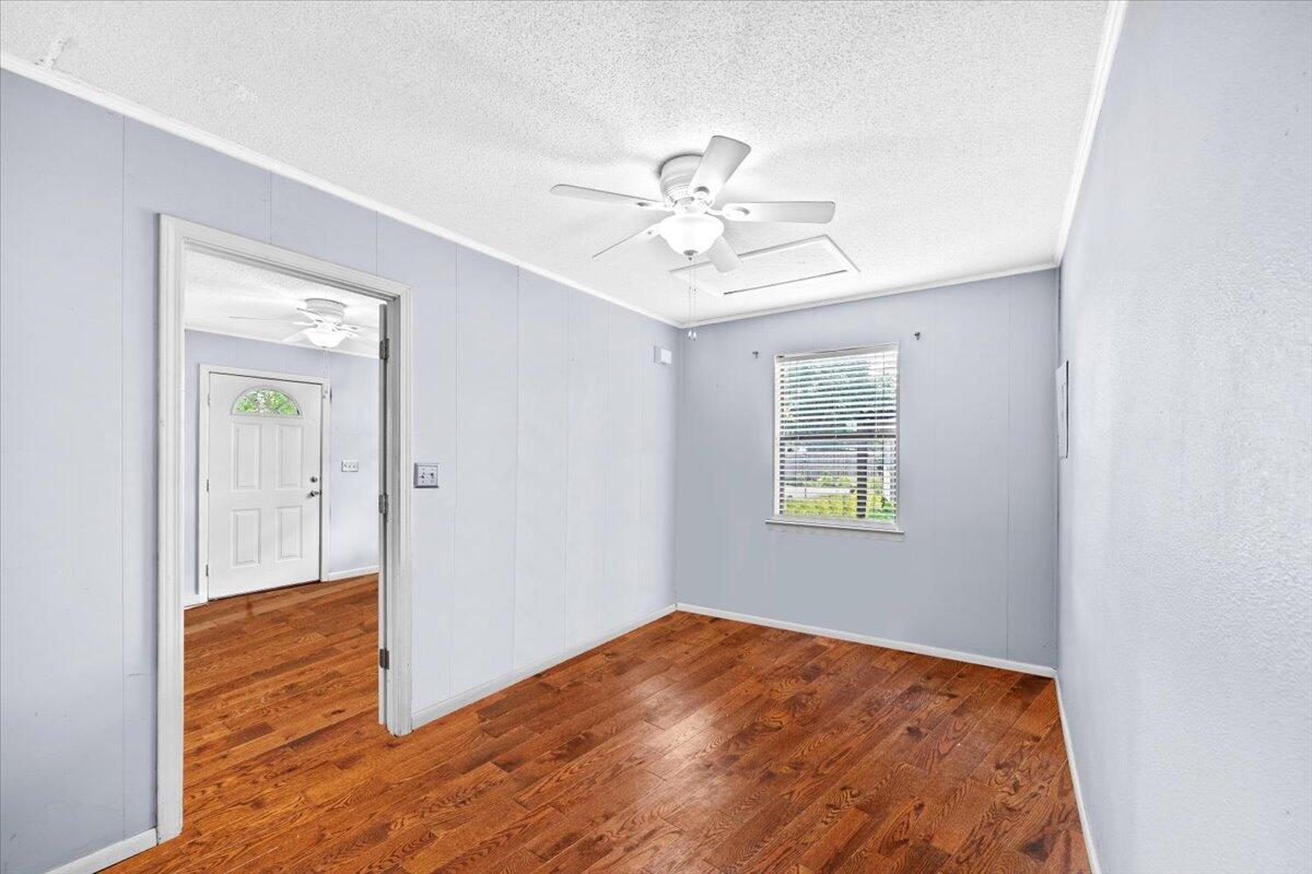 295 Garden Street Crestview, FL 32536 - Photo 29 of 33 a view of empty room with wooden floor and fan