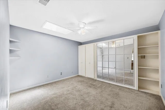 a bedroom with a bed chairs and lamps