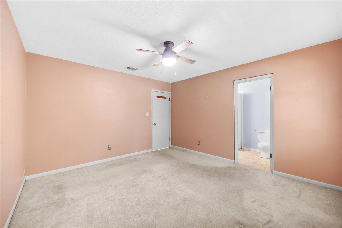 295 Garden Street Crestview, FL 32536 - Photo 9 of 33 an empty room with a ceiling fan and a window