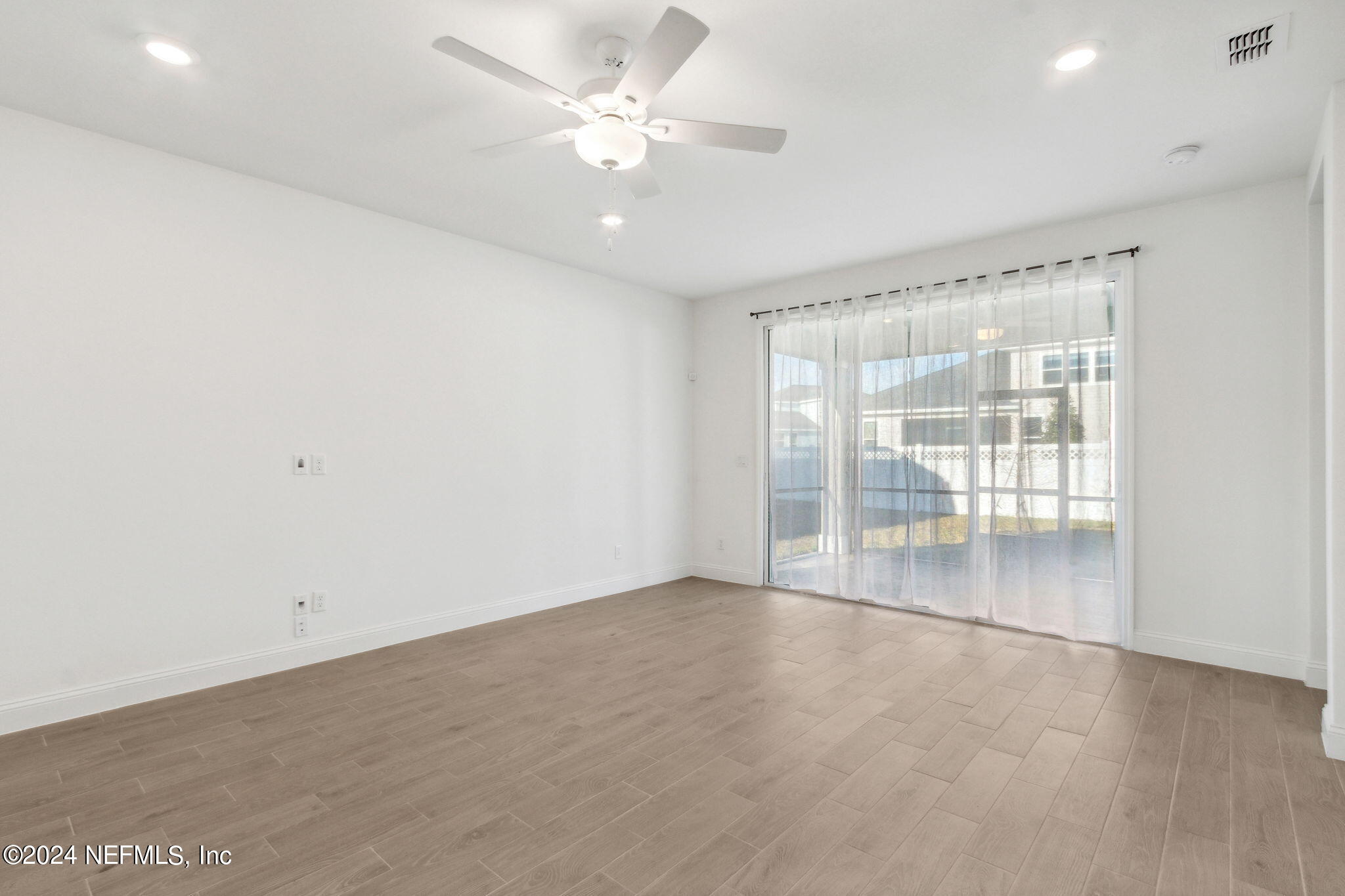 125 Varner Way St. Augustine, FL 32092 - Photo 21 of 87 an empty room with chandelier fan and windows