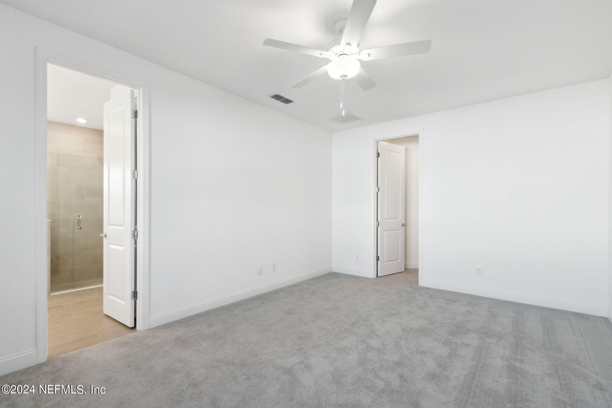 125 Varner Way St. Augustine, FL 32092 - Photo 24 of 87 an empty room with a ceiling fan and a bathroom