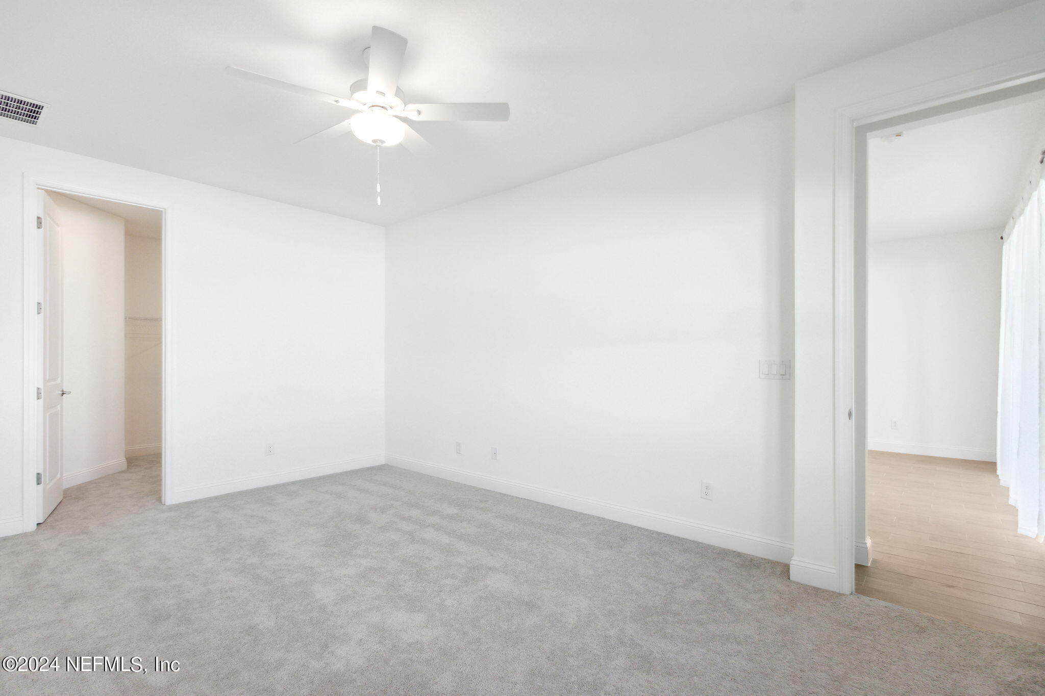 125 Varner Way St. Augustine, FL 32092 - Photo 25 of 87 an empty room with a ceiling fan and a window