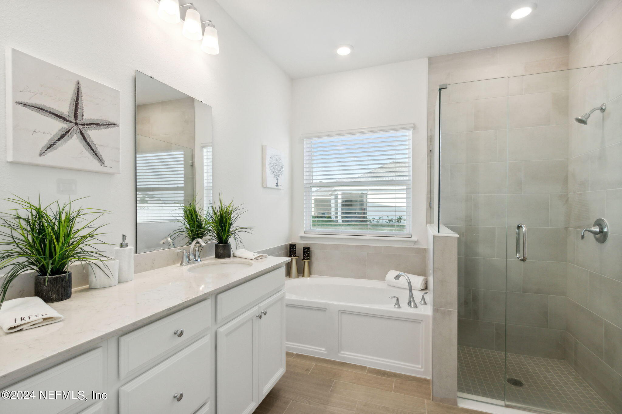 125 Varner Way St. Augustine, FL 32092 - Photo 28 of 87 a bathroom with a granite countertop bathtub a sink and a potted plant