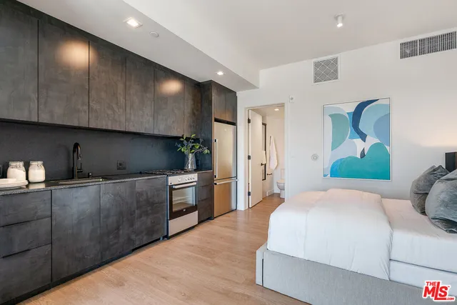 a spacious bedroom with a bed and a cabinets