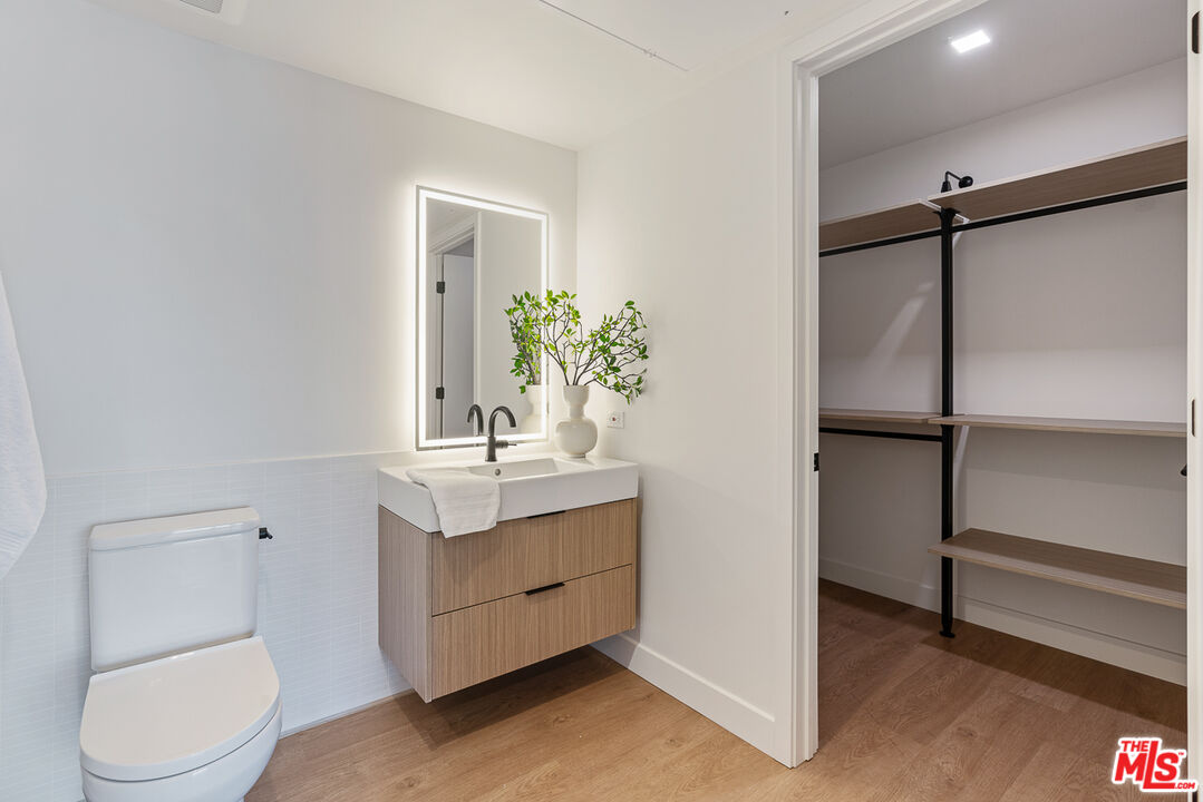 10700 Tabor Street, Unit PH5 Los Angeles, CA 90034 - Photo 6 of 26 a bathroom with a granite countertop sink toilet and shower