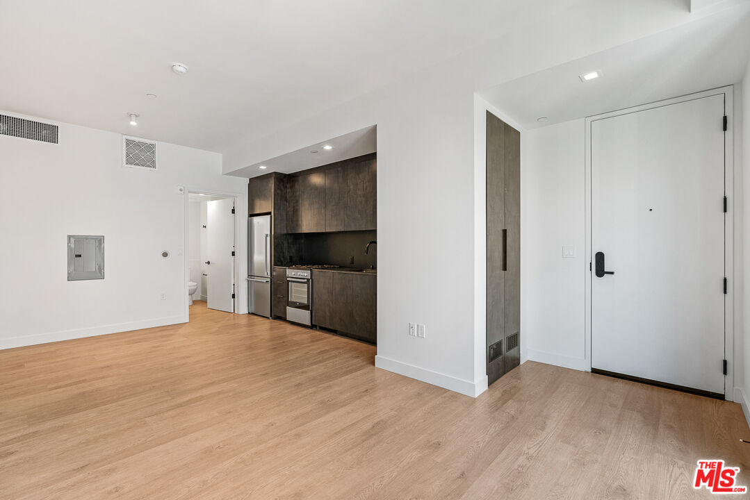 10700 Tabor Street, Unit PH5 Los Angeles, CA 90034 - Photo 9 of 26 a view of a kitchen with a sink and a refrigerator