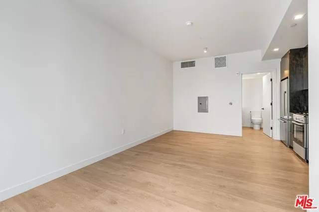 a view of a kitchen with a sink and a refrigerator