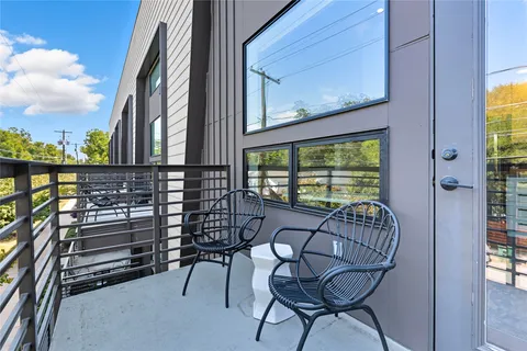 a view of balcony with a couple of chairs