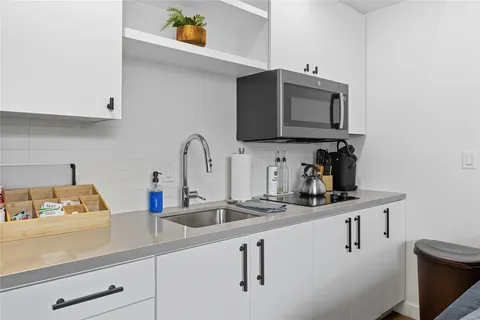 a kitchen with a sink and cabinets