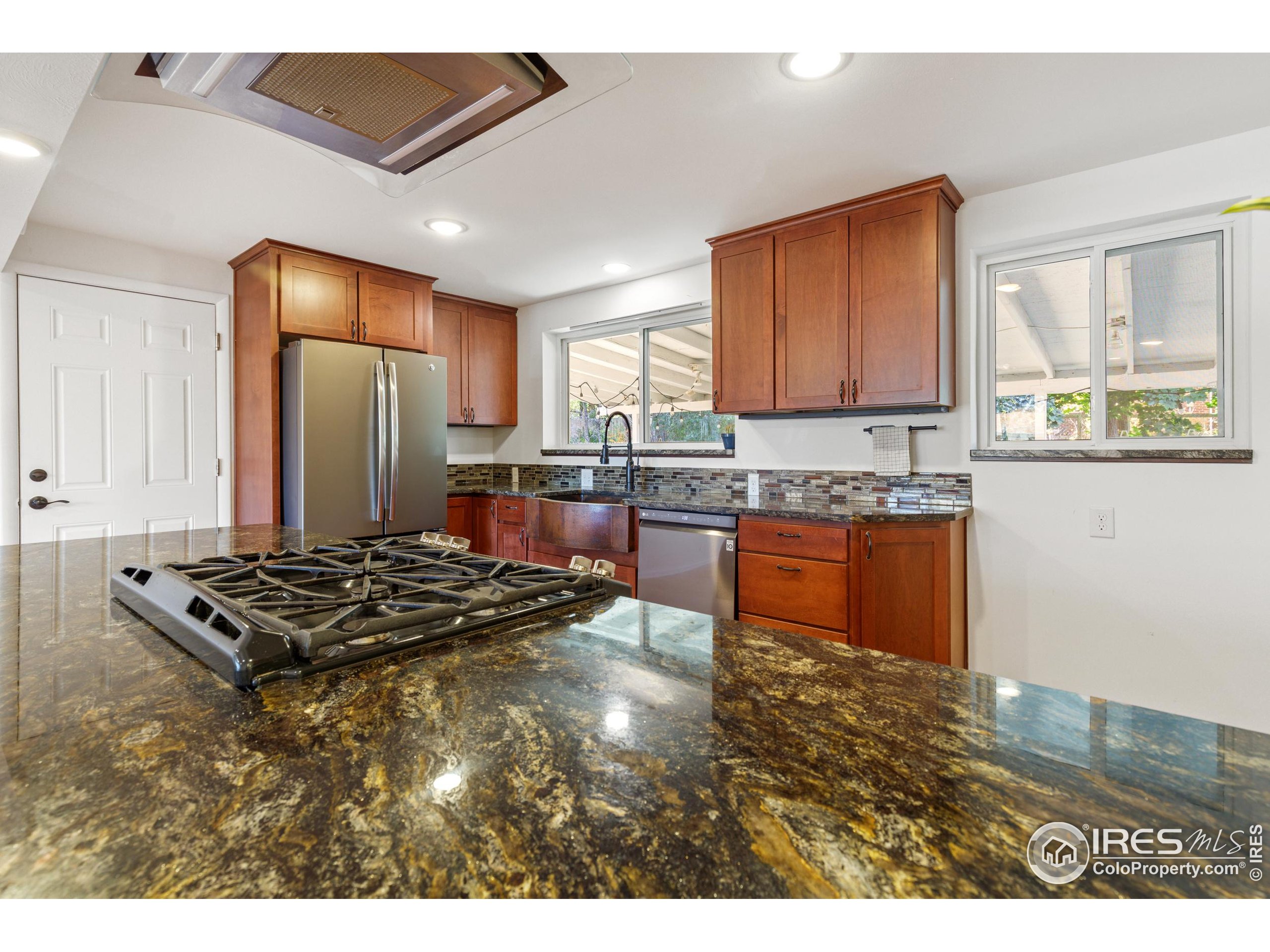 725 South 45th Street Boulder, CO 80305 - Photo 11 of 44 a kitchen with stainless steel appliances granite countertop a stove a sink dishwasher and a refrigerator