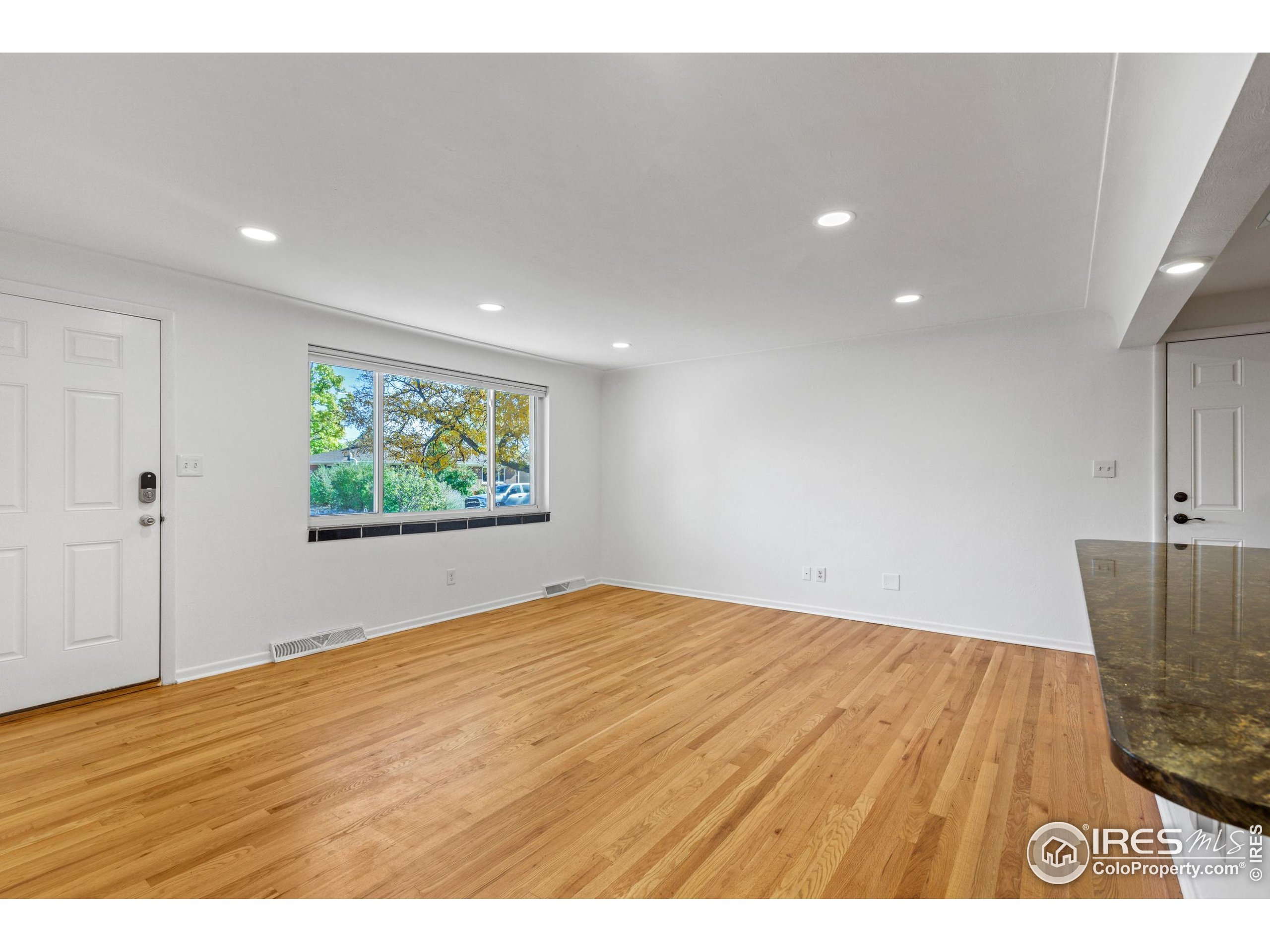 725 South 45th Street Boulder, CO 80305 - Photo 16 of 44 a view of an empty room with wooden floor and window