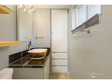 a room with a walk in closet and wooden floor