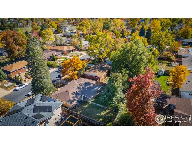 a kitchen with stainless steel appliances granite countertop a stove a sink and a refrigerator with wooden floor