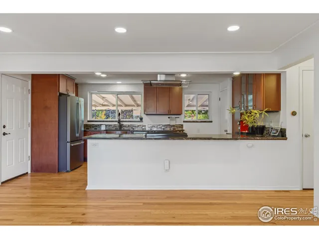 a kitchen with stainless steel appliances granite countertop a stove a sink dishwasher and a refrigerator