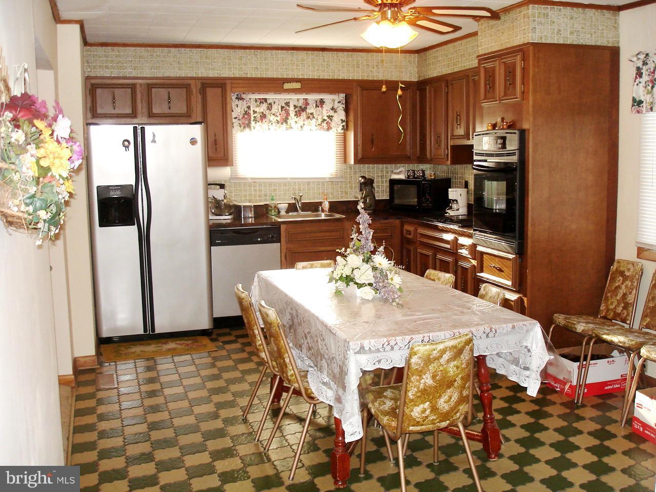 373 Nicholson Road Baltimore, MD 21221 - Photo 2 of 25 a kitchen with stainless steel appliances kitchen island granite countertop a refrigerator and a stove